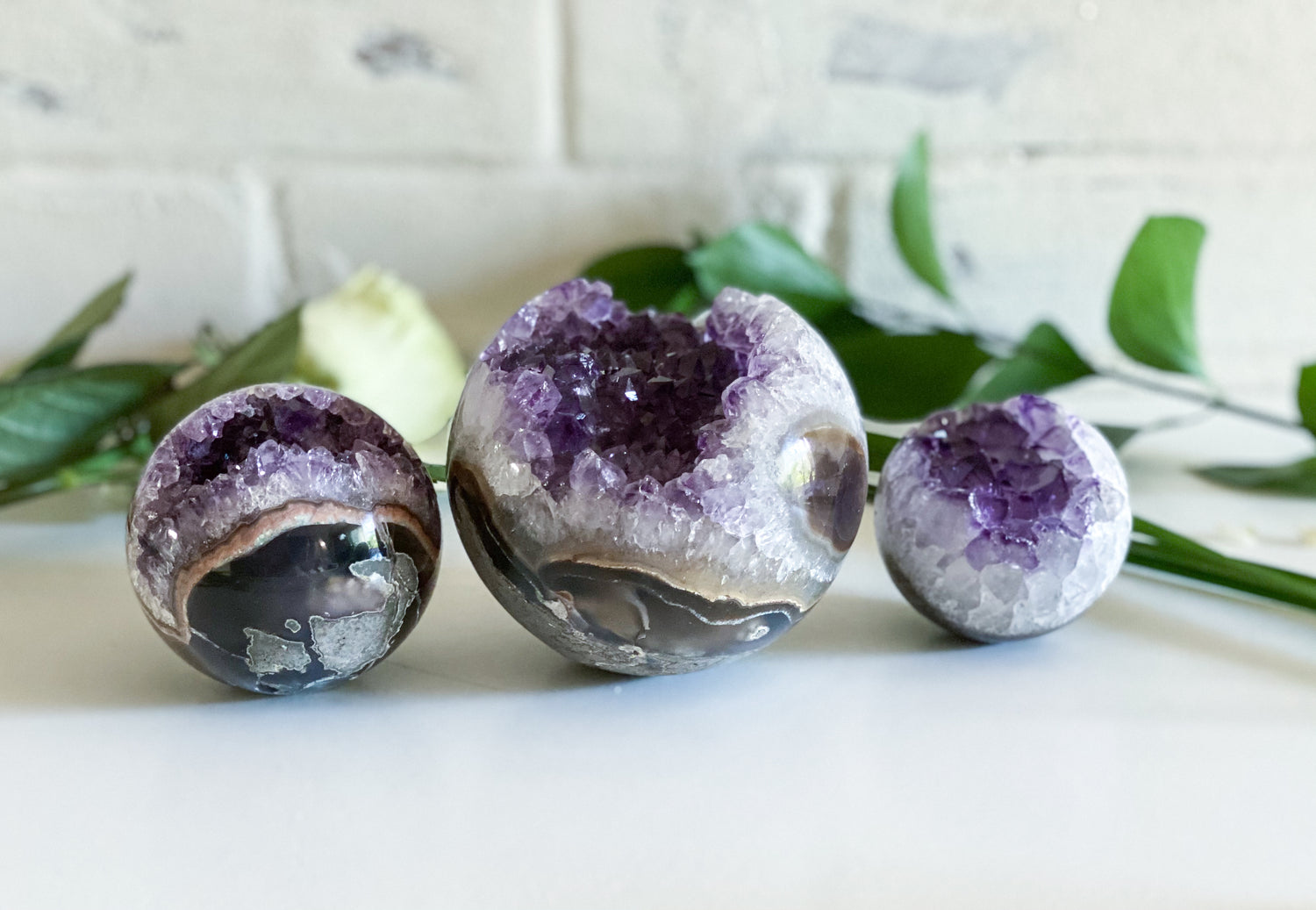 Amethyst spheres on a table with eucalypstus leaves 